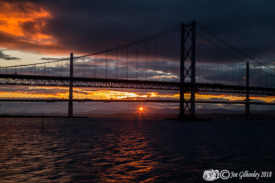 Sunset through heavy clouds at Forth Road Bridge 
