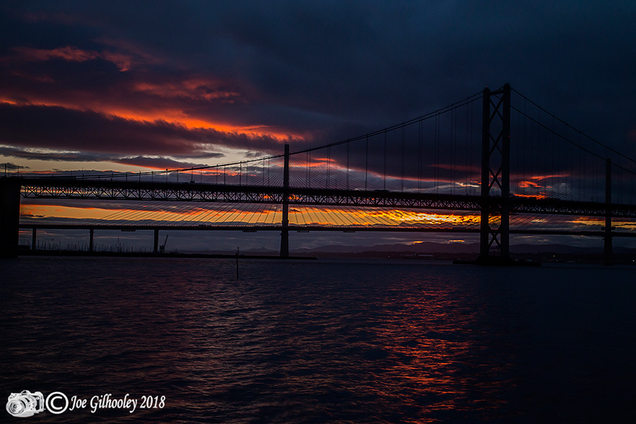 Sunset through heavy clouds at Forth Road Bridge 
