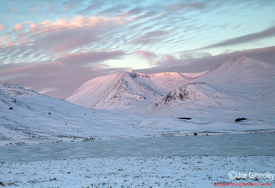 A frozen Lochan na h-Achlaise - the sun was just coming up behind my camera shining onto snowy mountains