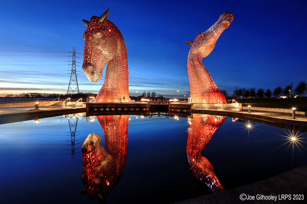 The Kelpies lit at night
