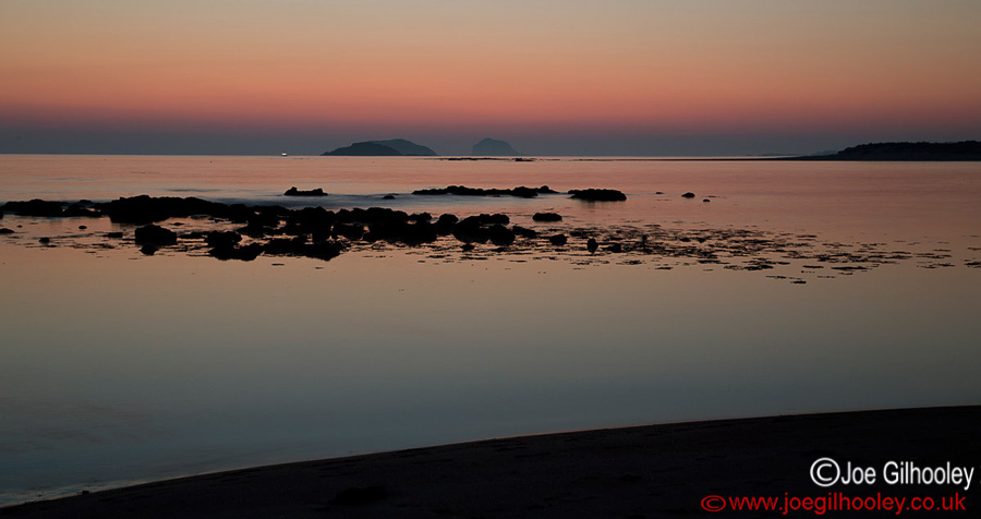 Sunrise at Yellowcraigs Beach. One hour before dawn. Craigleith Island and The Bass Rock in distance