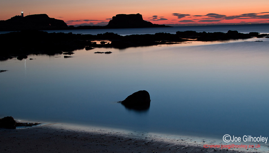 Sunrise at Yellowcraigs Beach. Two hours before dawn. Fidra Island with lighthouse light showing. Getting reflections from lighthouse light.