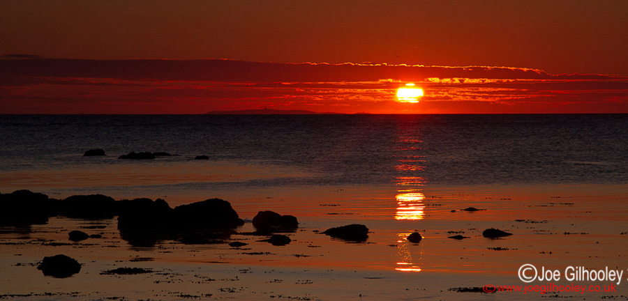 Sunrise at Yellowcraigs Beach. Sun now above horizon and reflections lovely.